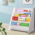 White bookshelf with children's books against a light blue wall.