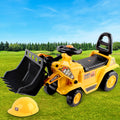 Toy bulldozer with a hard hat on grass under a blue sky